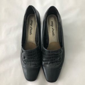 Woman’s grey pump dress shoe with heel